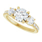 Elegant yellow gold three-stone engagement ring with claw prongs