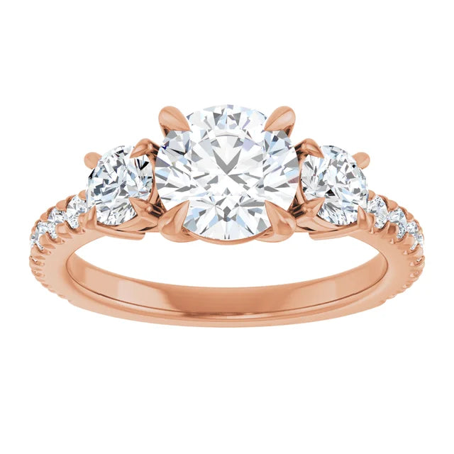 Rose gold engagement ring with three round diamonds