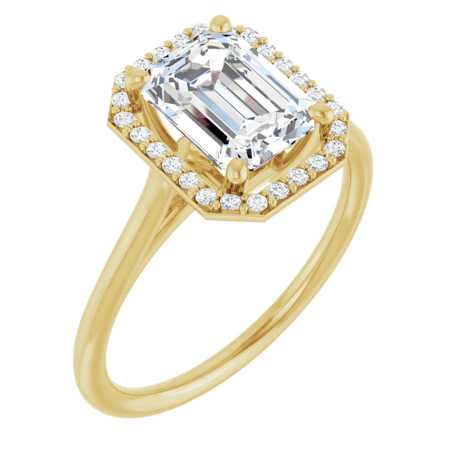 Emerald engagement ring with halo and split shank in yellow gold