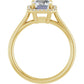 Simple emerald cut engagement ring with diamond halo in yellow gold