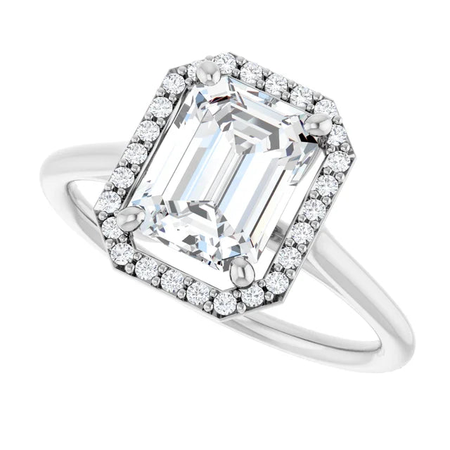 Elegant emerald engagement ring with halo in white gold