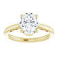 Timeless oval diamond engagement ring with a yellow gold band