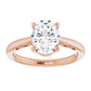 Sophisticated oval solitaire diamond ring in blush rose gold