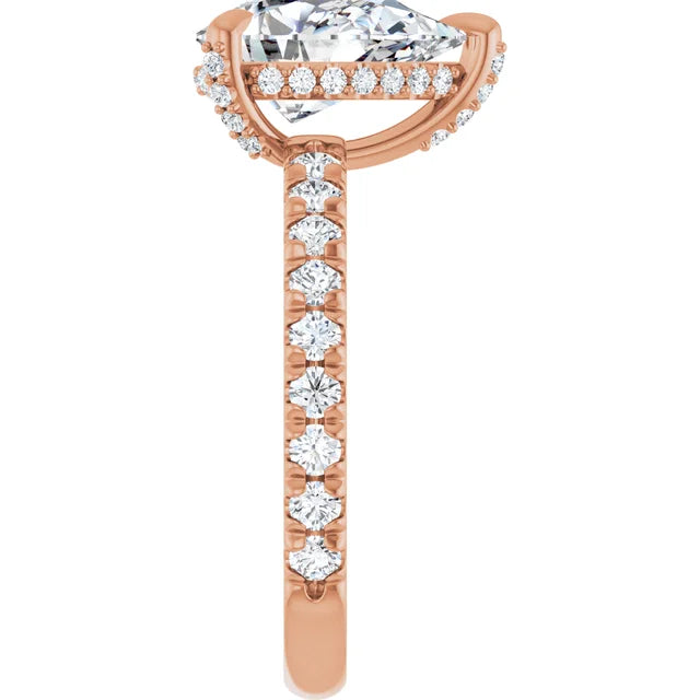 Side view of a white gold pear cut halo engagement ring